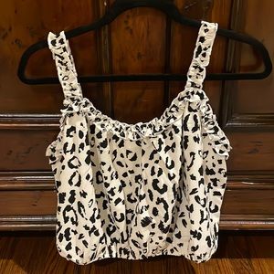 Cute tank blouse w/ detail straps u can wear it cropped or high waisted jeans.